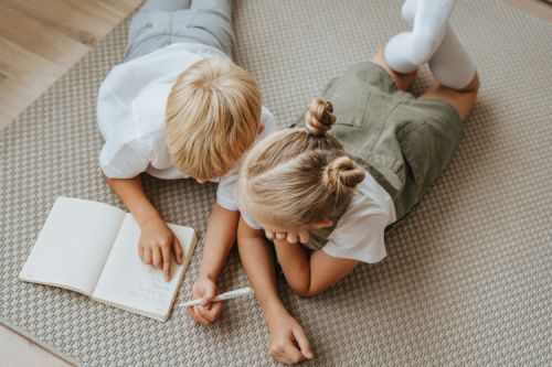 siblings doing schoolwork