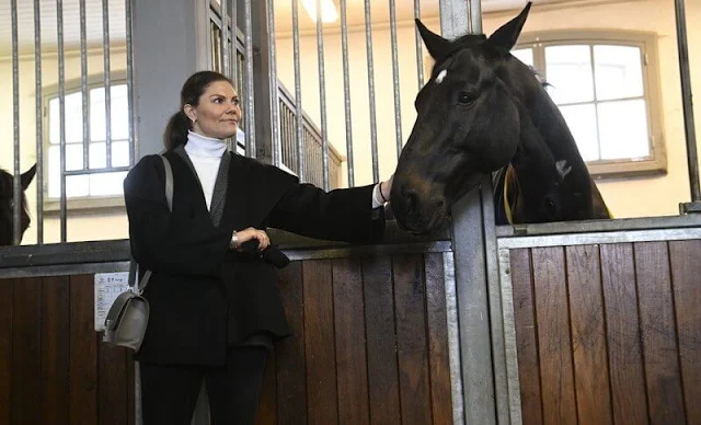 Crown Princess Victoria wore a black Annecy jacket by Toteme, and white Polana cashmere knit sweater by Andiata. Valentino boots