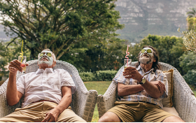 Two men drinking wine with face masks