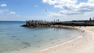 Tourists walking on seaside dock