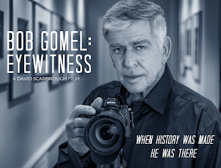 graphic for the movie "Bob Gomel: Eyewitness" with black and white photograph of Bob Gomel holding a camera