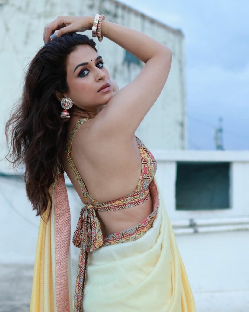 Shraddha Das Grabs Attention in a Bold Yellow Saree: The Enchanting Elegance The Bold Backless Feature: A Daring Statement