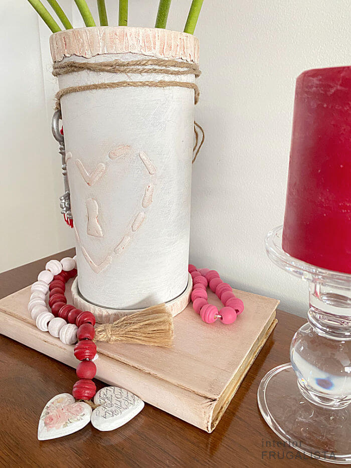 How to turn a vintage terracotta wine cooler from Italy into a romantic hand painted valentine vase with DIY raised stencil lock heart embellishments.