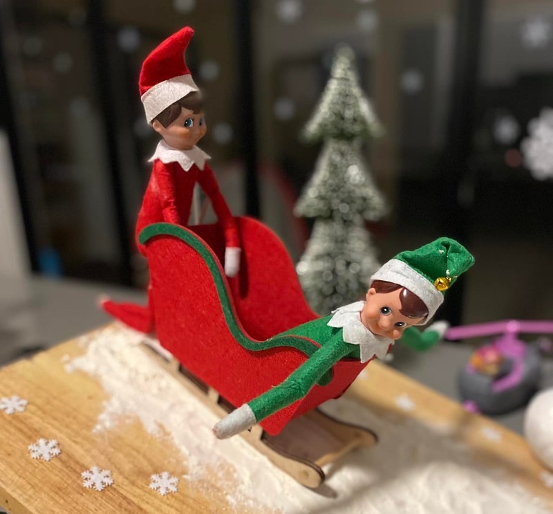 elves riding in a sleigh