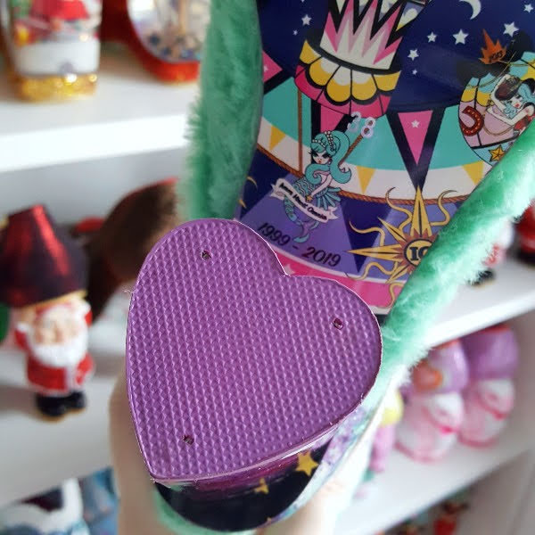 close up of heart shaped purple heel tip on boot
