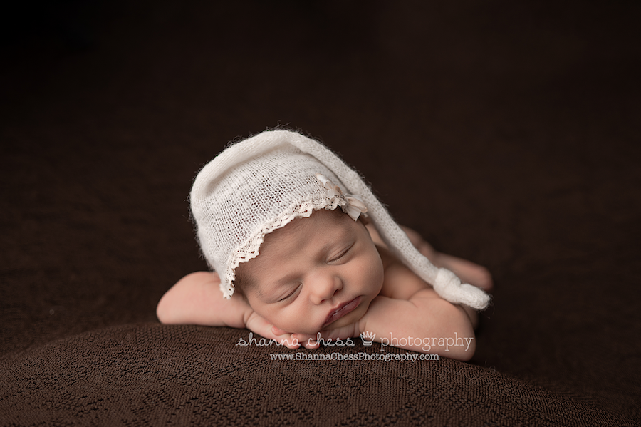 Newborn photo studio Eugene Oregon, infant girl in cream cap