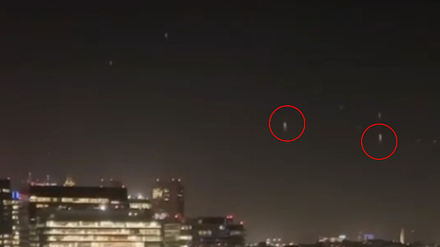 This image shows just a few UFOs flying upwards over Boston.