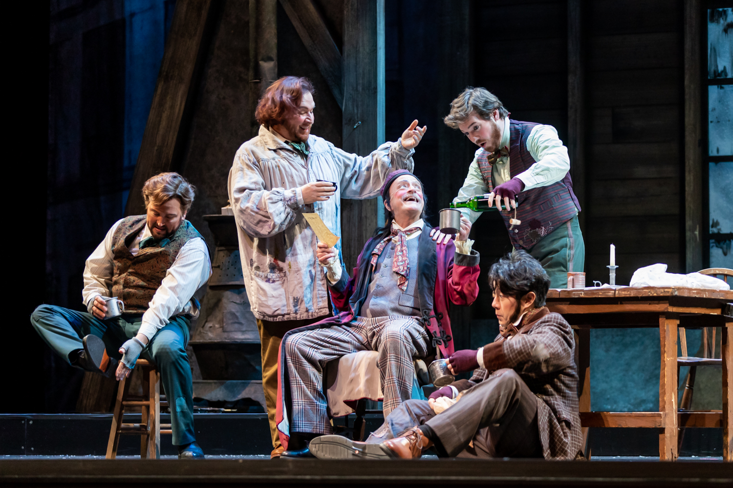 IN REVIEW: (from left to right) tenor SCOTT QUINN as Rdolfo, baritone LEVI HERNANDEZ as Marcello, bass-baritone DONALD HARTMANN as Benoît, baritone TIMOTHY MURRAY as Schaunard, and bass ADAM LAU as Colline in North Carolina Opera's January 2022 production of Giacomo Puccini's LA BOHÈME [Photograph © by Eric Waters Photography]