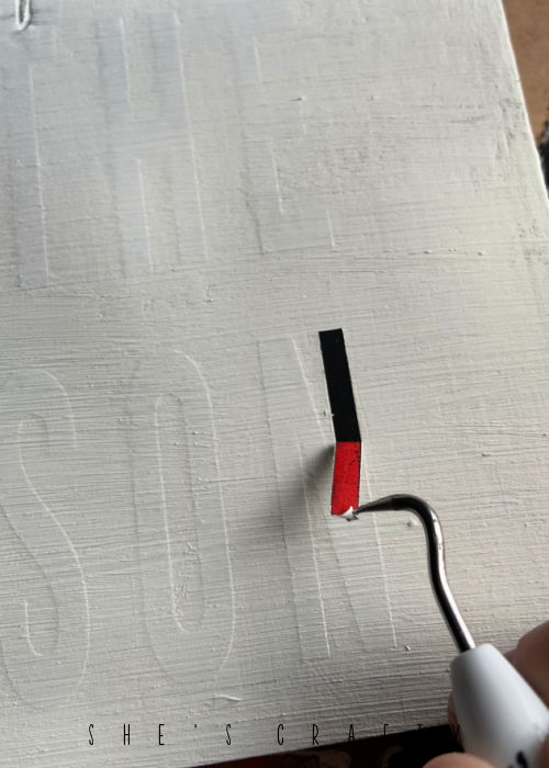 peel vinyl letters off with weeding tool