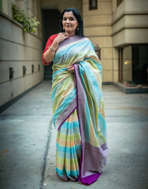 Banarasi silk saree with patola design body and paithani style pallu in cement grey.
