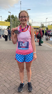 Me holding my Manchester Marathon medal.