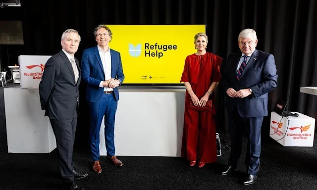 Queen Maxima wore a red silk blouse and red wide-leg trousers. Gianvito Rossi red pumps and Monies earrings. Dutch Council for Refugees