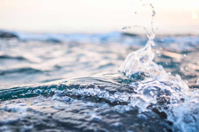 A closeup of the ocean, a small wave splashing into a little curl