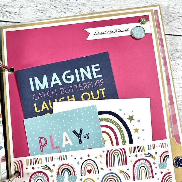 Childhood scrapbook album page with rainbows and a pocket