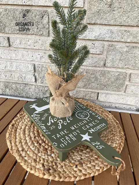 Photo of a Target Bullseye Playground cutting board riser with a Christmas upcycle.