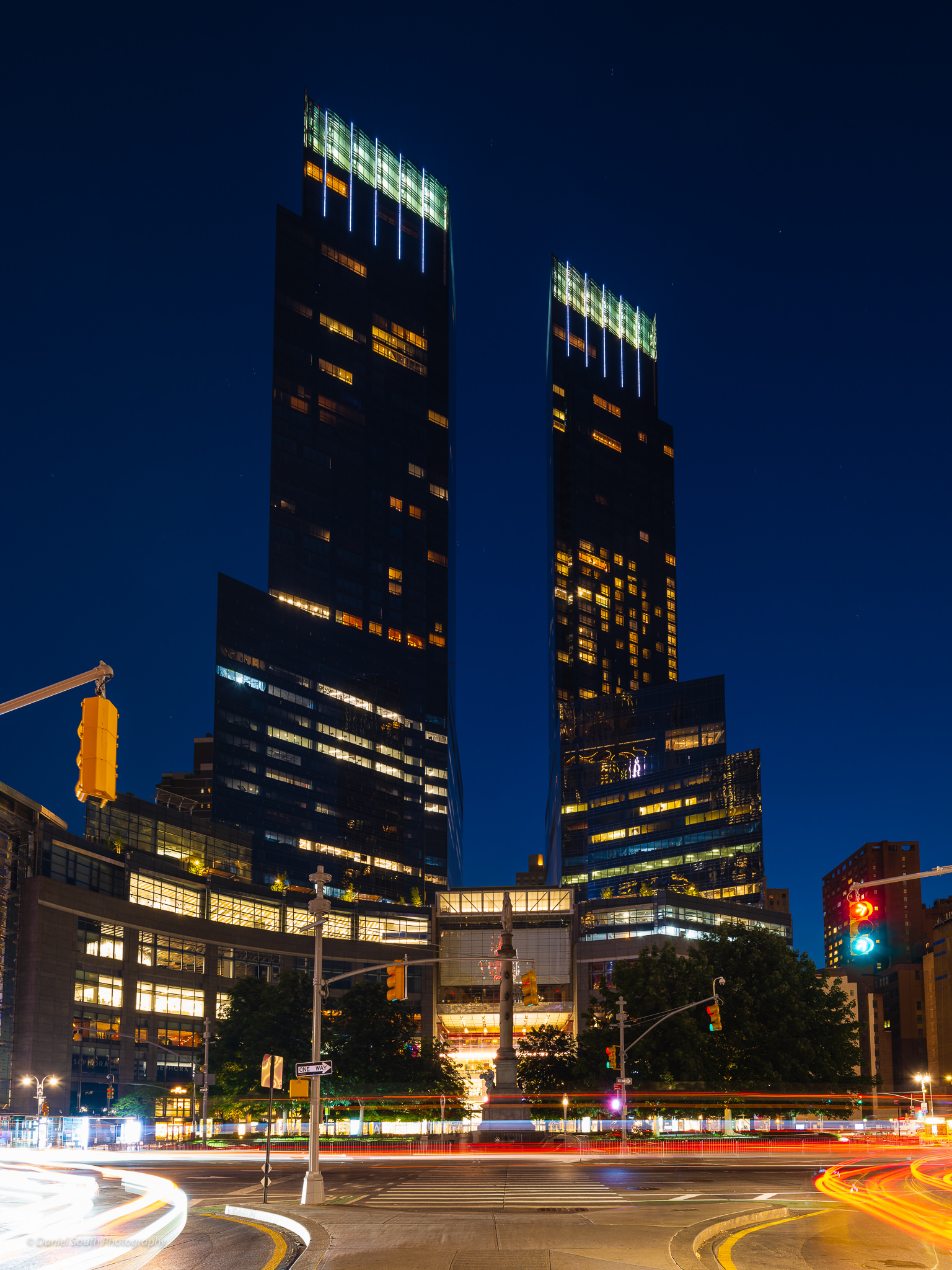 a night photo of the tall towers are columbus circle new york city