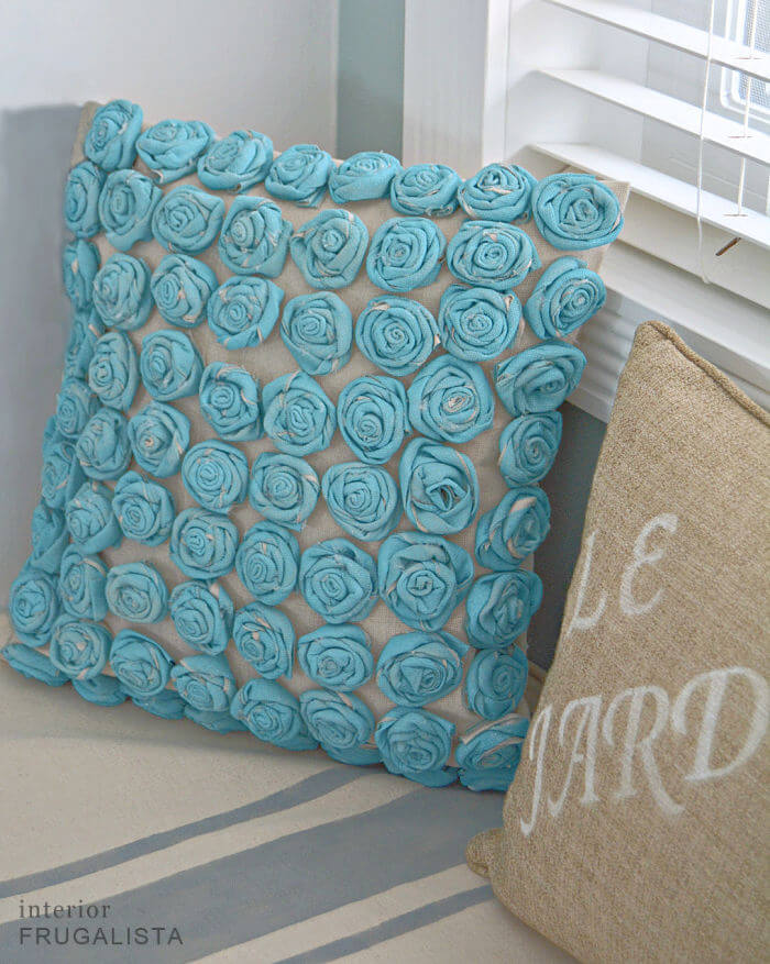 How to make fabric roses with an inexpensive drop cloth painted a pretty turquoise and sew a simple envelope style pillow cover for a bedroom.