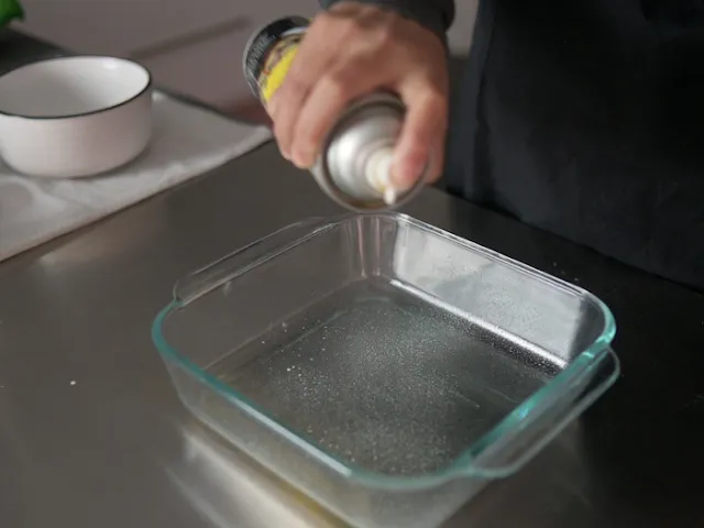 Spray some oil onto a square glass container