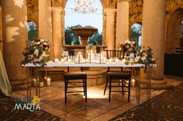 sweetheart table in bella collina atrium with flowers and candles