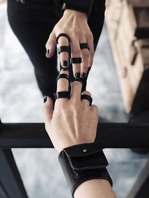 A Woman Wearing Black Leather Rings