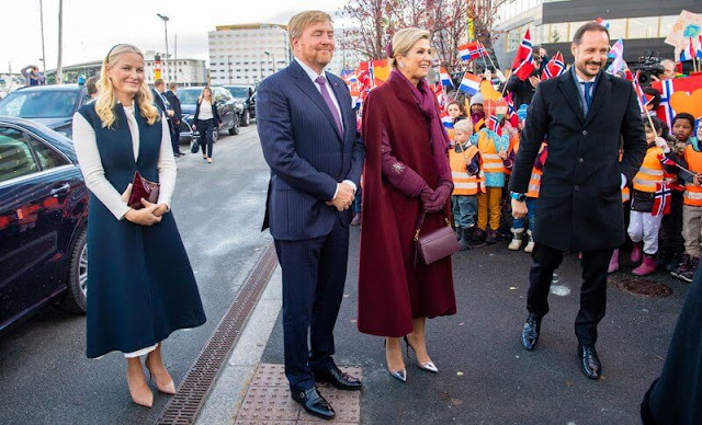 Queen Maxima wore Sirius wine-red coat by Claes Iversen. Crown Prince Haakon and Crown Princess Mette-Marit