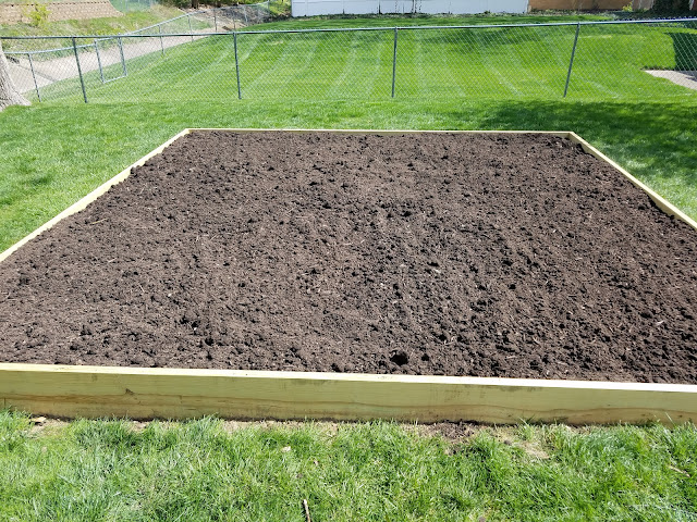 Filled raised garden bed with topsoil