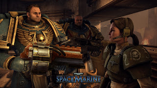 Titus and one of his space marine allies meet with the green armored Lieutenant Mira of the Imperial guard, in a weathered bunker. The cityscape outside burns.