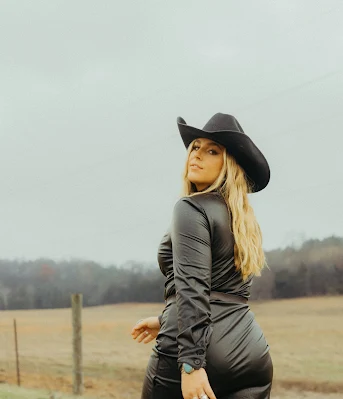 A Modern Women Wearing Leather Attire and Hat