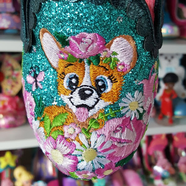 close up of flower and dog embroidery on front of shoe