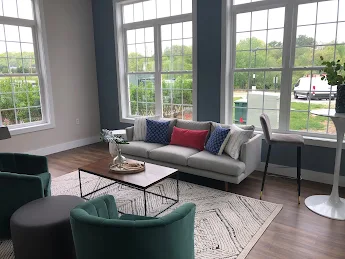 Resident lounge with couch, coffee table, and chairs