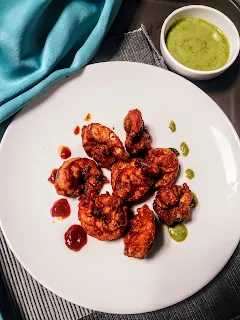 Serving prawns fry in a serving plate with green chutney