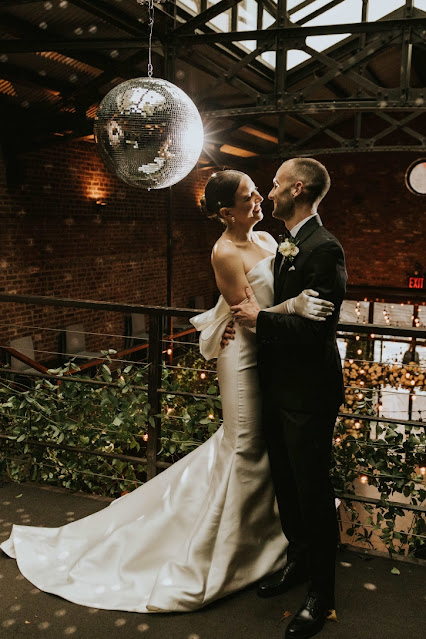 A Mirror Ball w/ motor and spotlight along with String Lights suspended in the main room for a wedding at The Foundry.