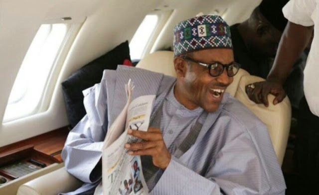 Alt: = "photo of President Buhari in a plane"