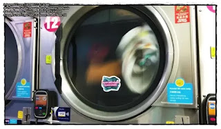 Pictures of clothes being dried in a dryer at the Cleanpro Express Taman Seroja self -service laundromat. Looks like the label shows this dryer uses a 50 cent coin. Also visible is a credit card reader machine which shows this machine accepts cashless payments using VISA cards