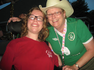 Me and my late friend Joyce smiling at a camp dance. I have a red t shirt and she has a green jersey and cowgirl style hat