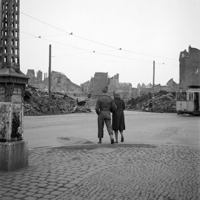 GI and woman looking at rubble of destroyed building after WWII in Frankfurt, Germany, 1947
