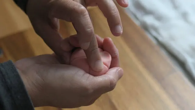 Using finger and push the sakura petal towards thumb of the other hand