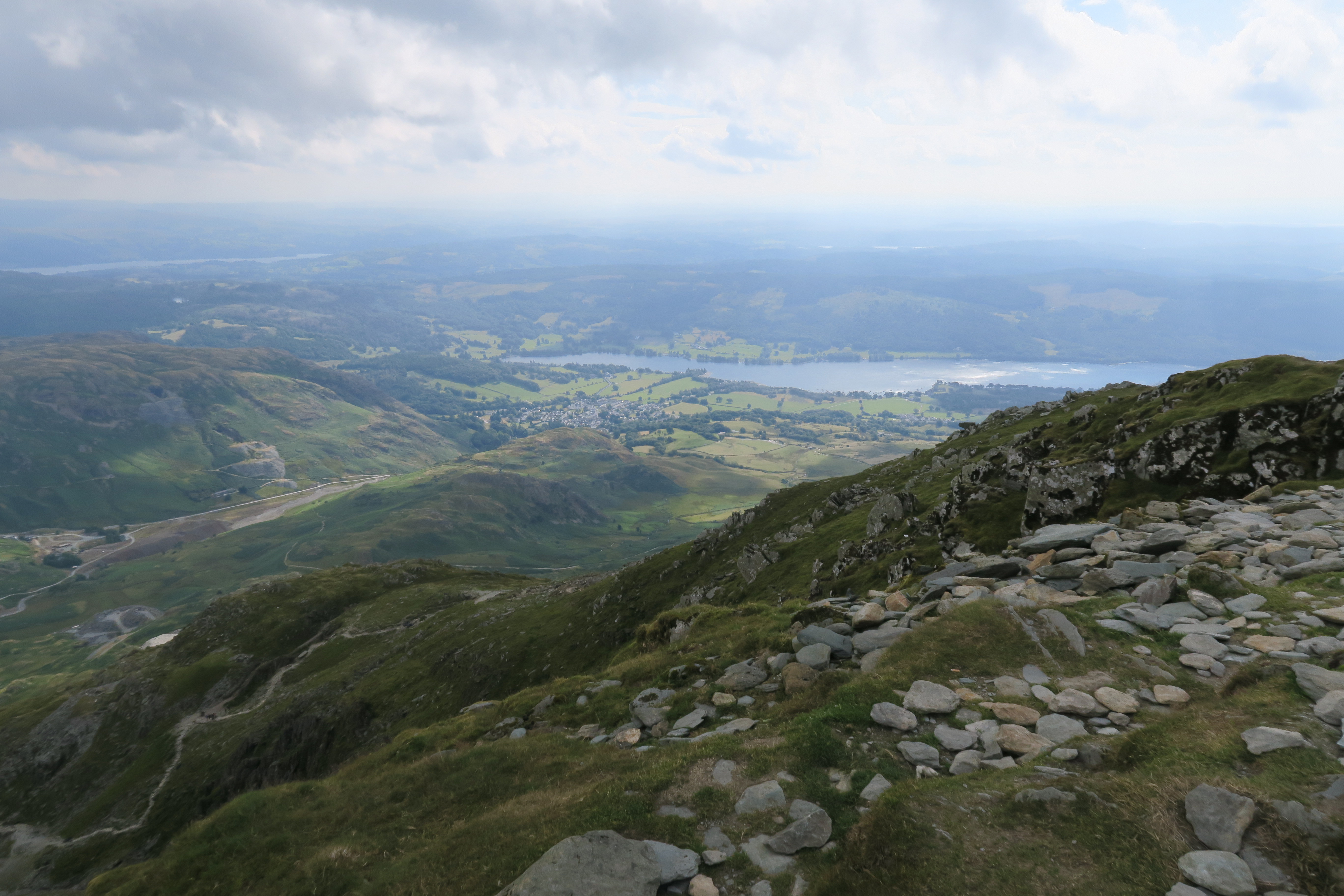 View from the top of Coniston Old Man. Beautiful countryside can be seen all around as well as Coniston town and Lake in the background.