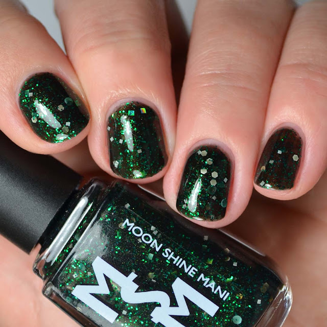 black jelly nail polish with green glitter swatch