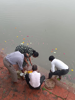 Image of four people disbursing food in waters