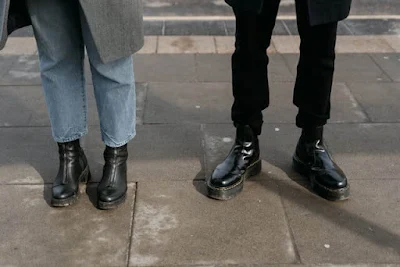 Two Persons Wearing Black Leather Boots