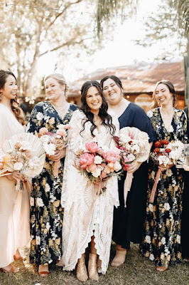 bride holding flowers with bridesmaids
