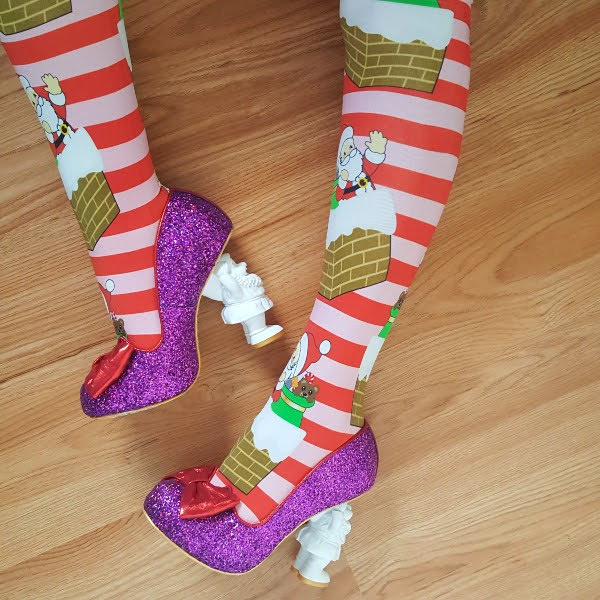 wearing striped festive tights with purple glitter shoes with Santa shaped heels to paint