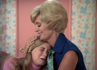 Carol comforts a crying Marcia in the girls' room.