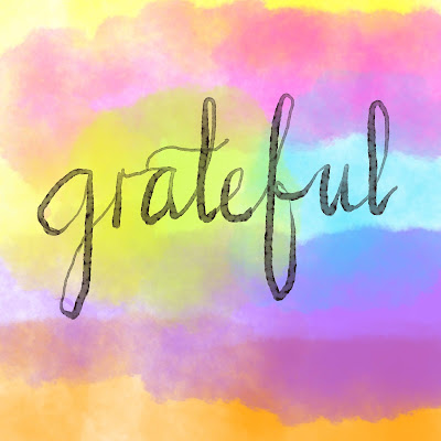 Grateful in Watercolour lettering on a multi-coloured digital watercolour background.