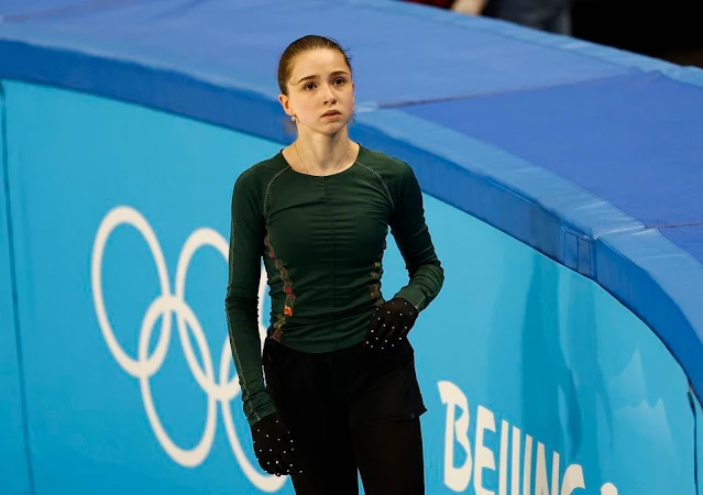 Aparentando tristeza, Kamila Valieva se posiciona no canto do rink de patinação