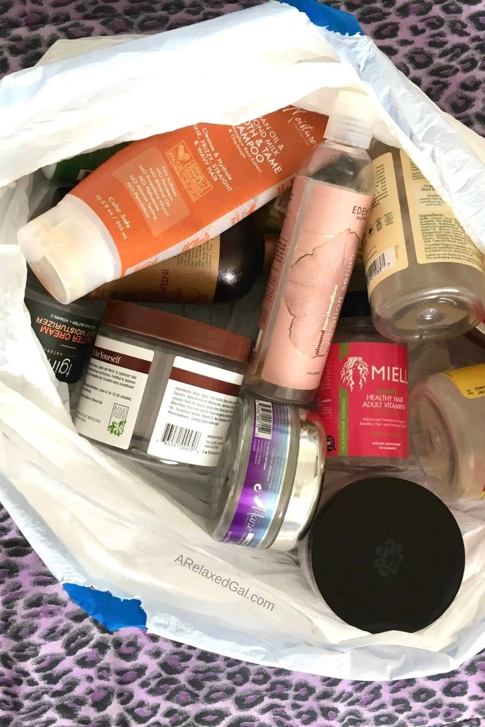 Old hair products that have expired sitting in a trash bag.