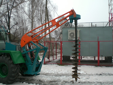 hydraulic auger standing in snow