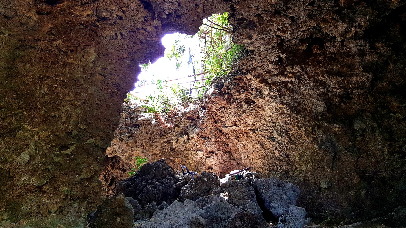 sinkhole viewed inside the cave-like picnic areas with a view of the sea at Canhugas Nature Park in Hernani Eastern Samar