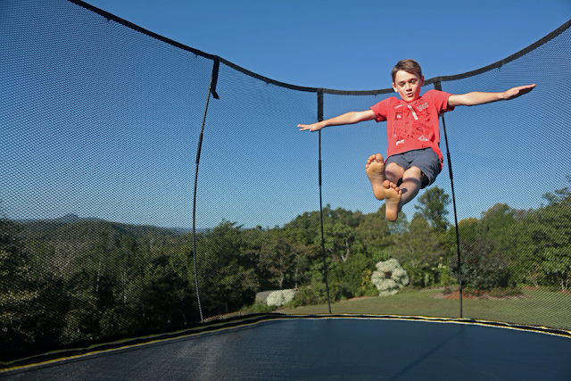 child bouncing on trampoline